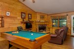 Living Room with Wood Fireplace and Pool Table